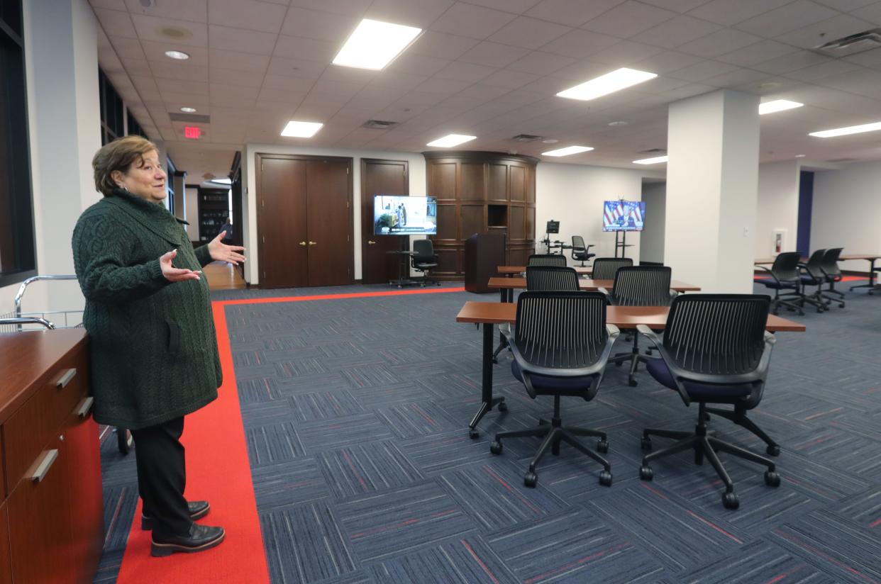 State & Federal Communications President & CEO Elizabeth Bartz shows off a meeting room in the firm's new 27,000-square-foot office space located on the third floor of the former O'Neil's department store on Tuesday in Akron.