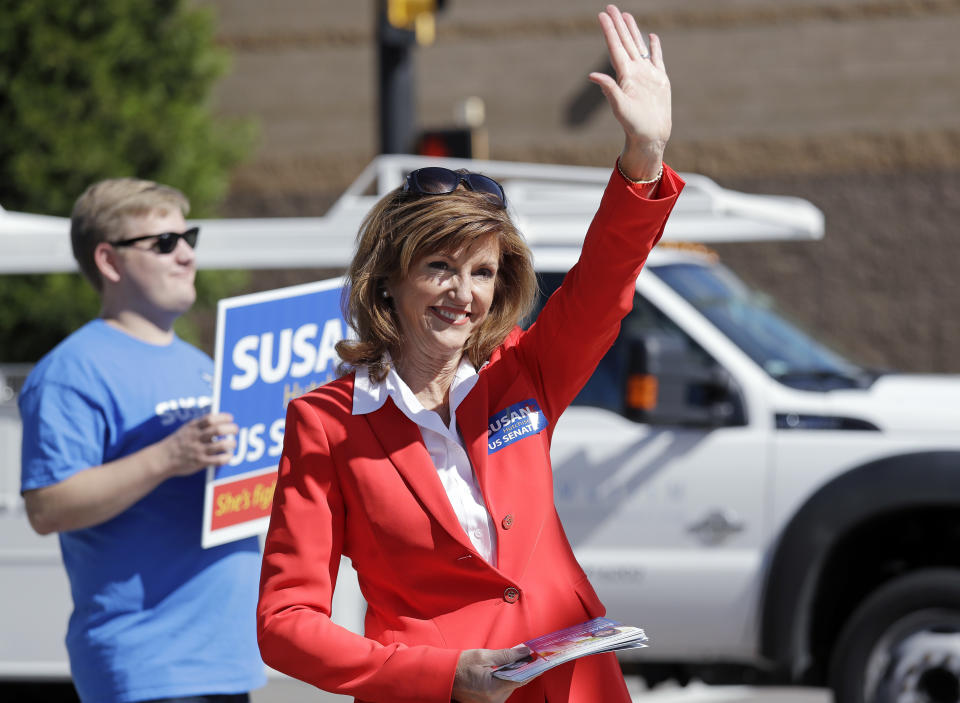 In this Sept. 17, 2018 photo, Republican U.S. Senate candidate Susan Hutchison waves as she campaigns outside a Boeing plant in Renton, Wash. Hutchison, who spent two decades as a Seattle TV news anchor before leading the state GOP party for five years, is running against Democratic incumbent Sen. Maria Cantwell. (AP Photo/Elaine Thompson)