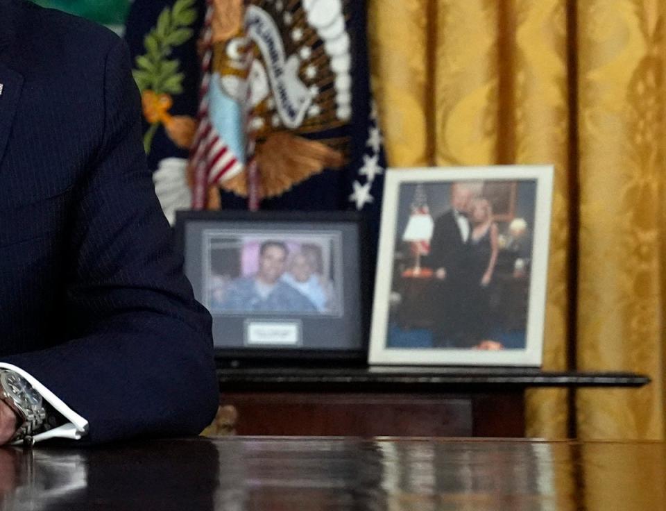 A picture of Biden and First Lady Jill sat to his right when he spoke from the Oval Office (POOL/AFP via Getty Images)