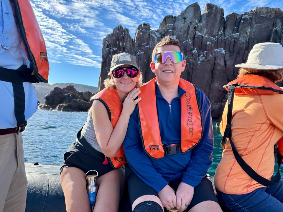 Terri Peters and her husband on a boat wearing life vests.