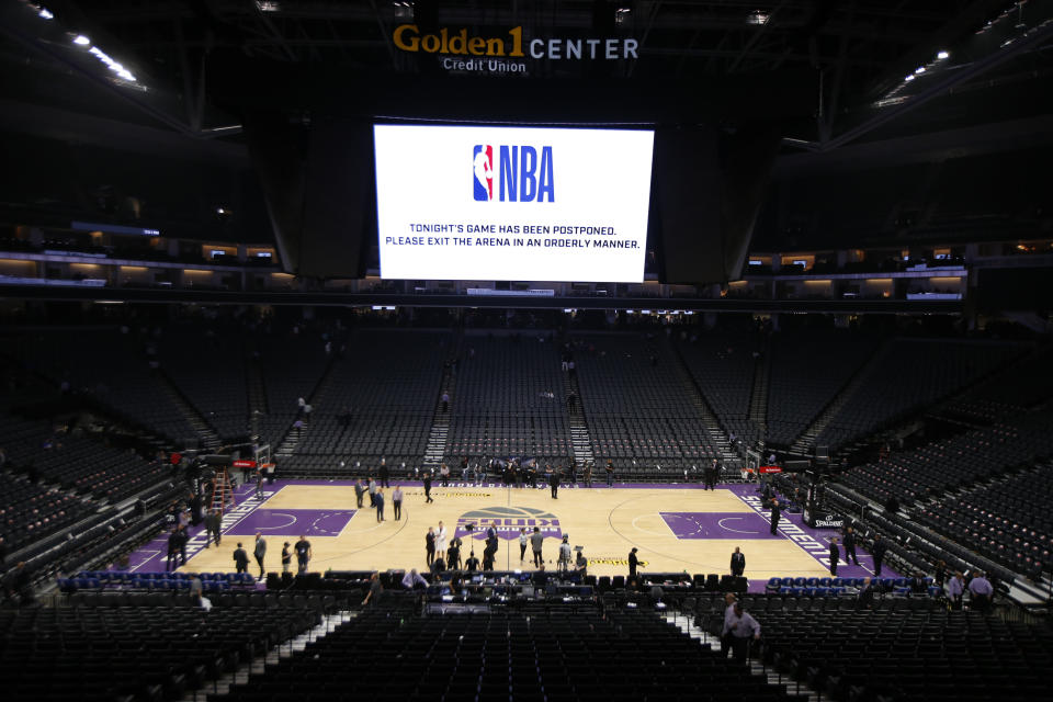 The Golden 1 Center center empties out after the NBA basketball game between the New Orleans Pelicans and Sacramento Kings was postponed at the last minute in Sacramento, Calif., Wednesday, March 11, 2020. The postponement was due to what the league said was an "abundance of caution," because official Courtney Kirkland, who was scheduled to work the game, had worked the Utah Jazz game earlier in the week. A player for the Jazz tested positive for the coronavirus. (AP Photo/Rich Pedroncelli)