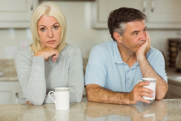 Older man and woman turned away from one another as if annoyed