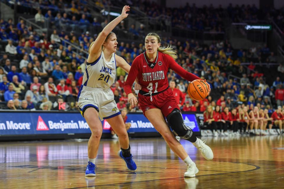 USD's forward Alexi Hempe (41) drives to the basket on Monday, March 11, 2024 at Denny Sanford Premier Center in Sioux Falls.