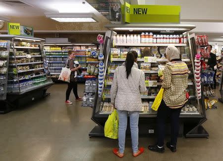 Customers look at a food display in the food hall at a Marks & Spencer shop in central London May 21, 2013. REUTERS/Suzanne Plunkett