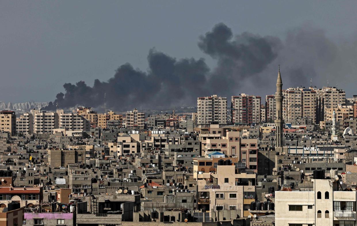 <p>Smoke billows from an Israeli air strike in Gaza city controlled by the Palestinian Hamas movement, on May 11, 2021.</p> ( (Photo by MAHMUD HAMS/AFP via Getty Images))