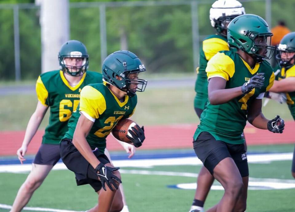 Central Cabarrus Chinua Ezeigbo blocks for his teammate as they run a play at the High School football prospect day recruiting showcase at Hickory Ridge High School Kelly Hood