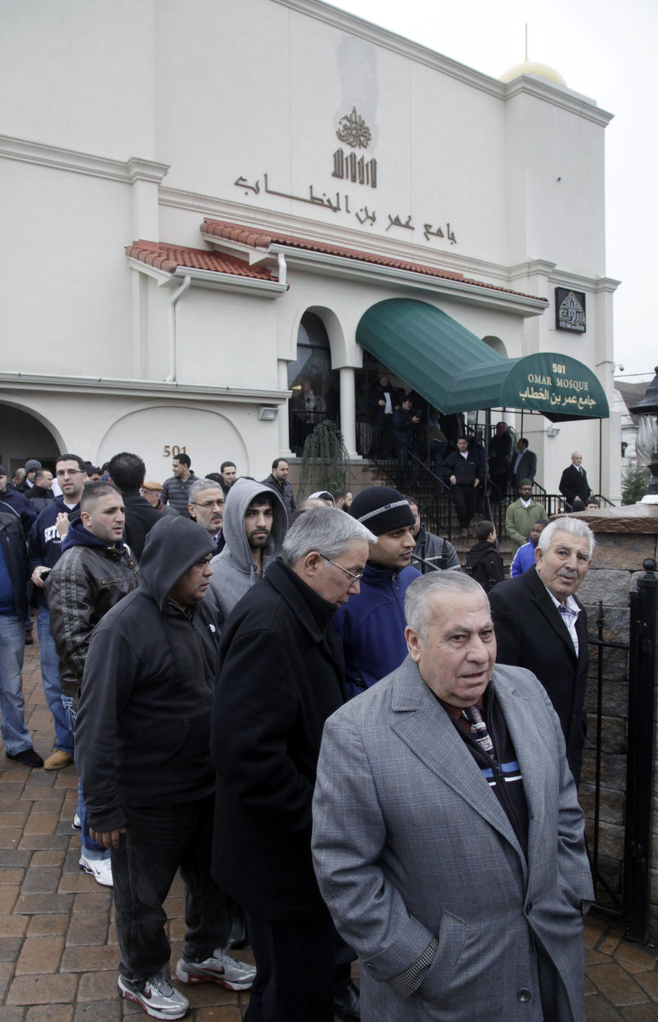 FILE - In this Feb. 24, 2012, file photo, a large crowd leaves the Masjid Omar mosque following afternoon prayers in Paterson, N.J. The Masjid Omar mosque was identified as a target for surveillance in a 2006 New York Police Department report uncovered by The Associated Press. The NYPD announced on Tuesday, April 15, 2014, that it has disbanded the special unit responsible for the surveillance program. (AP Photo/Mel Evans, File)