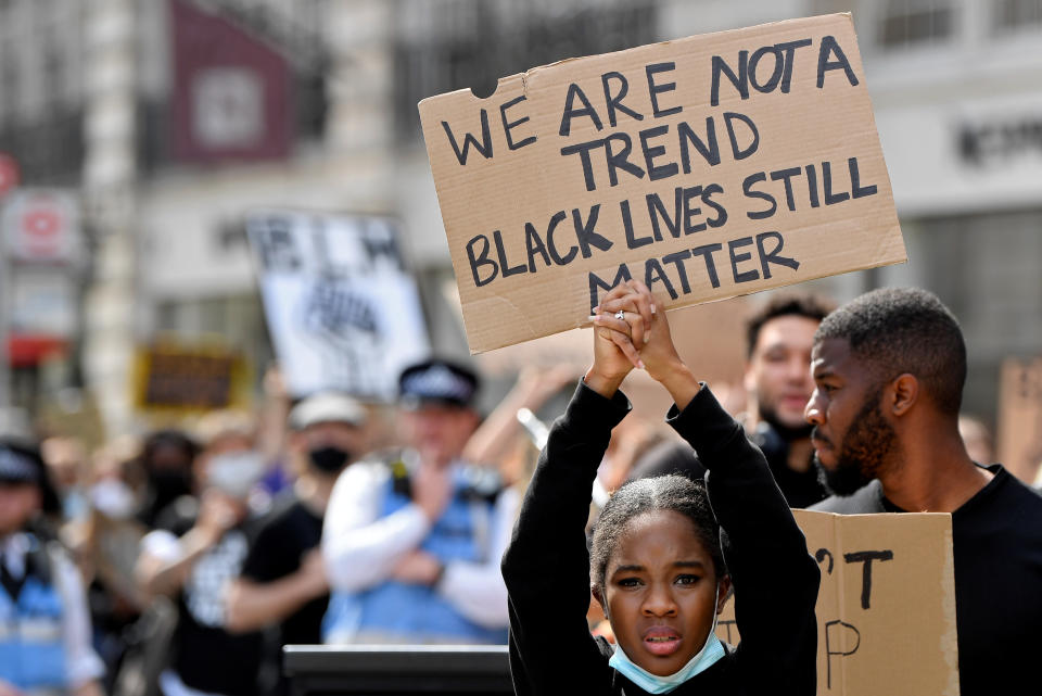 A protestors holds up a sign during a Black Lives Matter march in London, Britain, June 28, 2020. REUTERS/Toby Melville     TPX IMAGES OF THE DAY