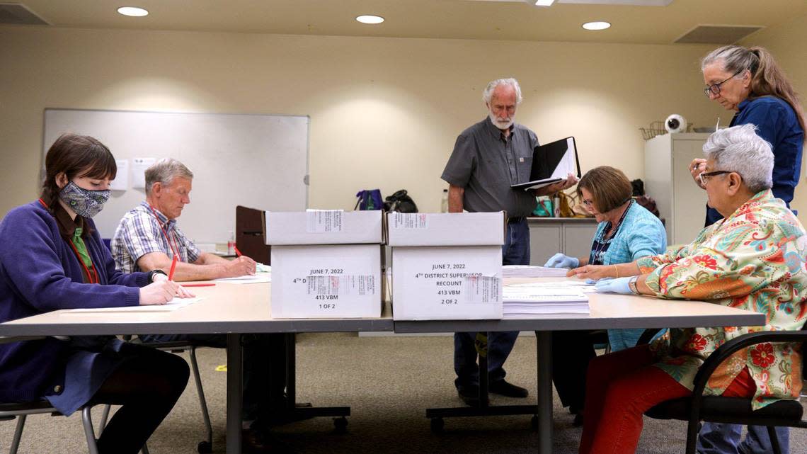 From left, special recount board members Lucia Maceri, Rick Ulsh, Ann Tapper and Rochelle Freidman hand count ballots on Aug. 10, 2022 at the Clerk-Recorder’s Office. Standing are observers Richard Patten and a woman who declined to share her name. The recount was for the San Luis Obispo County Board of Supervisors race between Lynn Compton and Jimmy Paulding. David Middlecamp/David Middlecamp@thetribunenews.