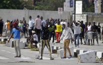 People protest at the Lekki toll gate in Lagos, Nigeria, Wednesday Oct. 21, 2020. Nigerians protesting against police brutality stayed on the streets in Lagos on Wednesday, breaking the government curfew following a night of chaotic violence in which demonstrators were fired upon, sparking global outrage. ( AP Photo/Sunday Alamba)