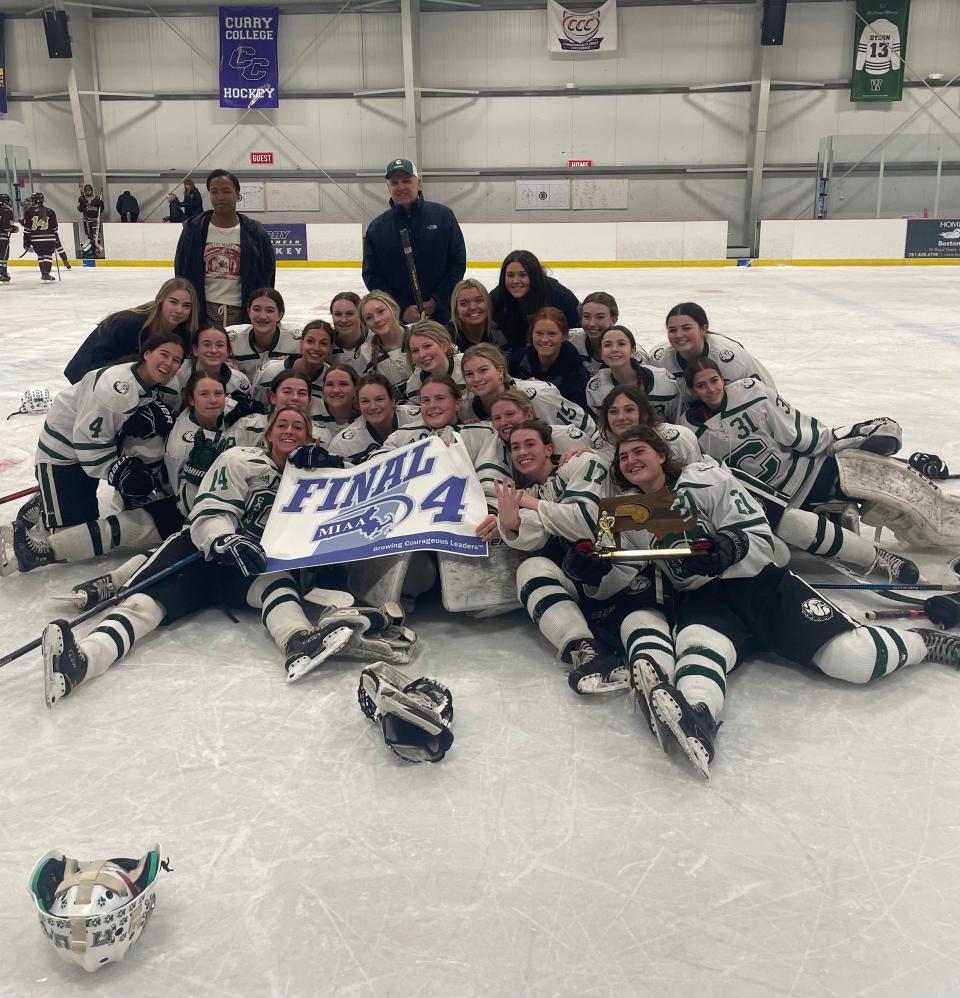 The Canton High girls ice hockey team poses for pictures with a Division 2 Final Four trophy and MIAA banner following the Bulldogs' 3-0 win over Algonquin at Canton Ice House on March 9, 2023.