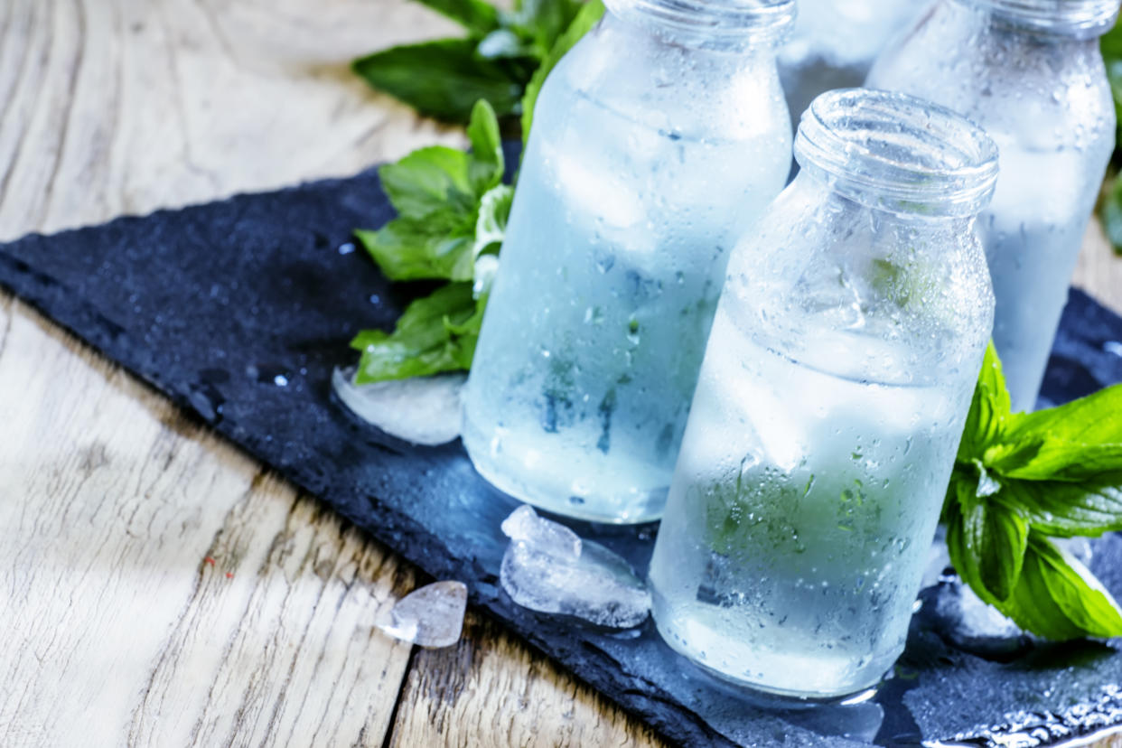 Hydration experts recommend water be stored in glass bottles — not plastic — for maximum flavor and quality. (Photo: Getty Creative)