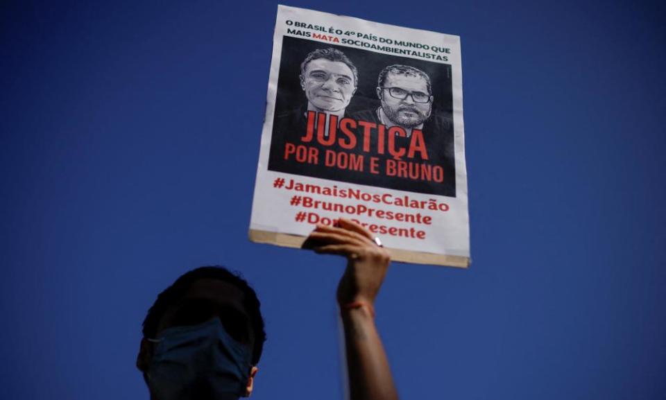 A demonstrator holds a sign demanding justice for journalist Dom Phillips and indigenous expert Bruno Pereira, who were murdered in the Amazon