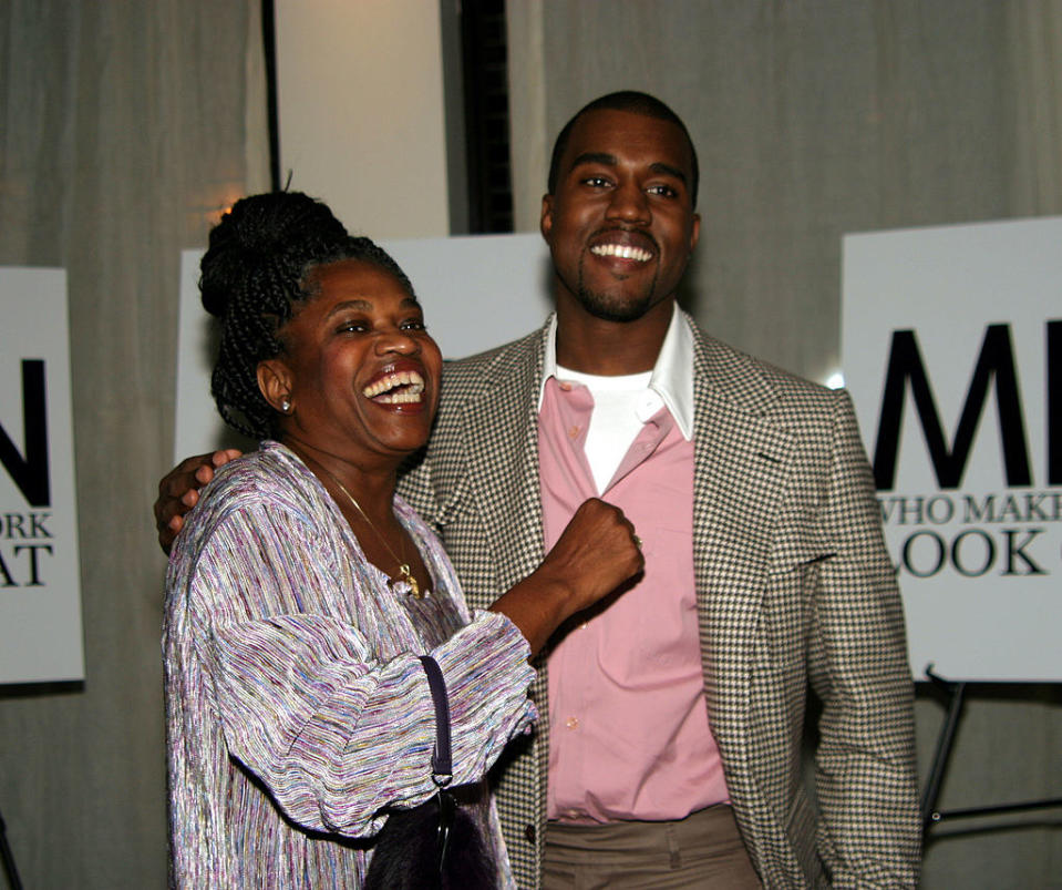 Kanye with his arm over his mother's shoulder