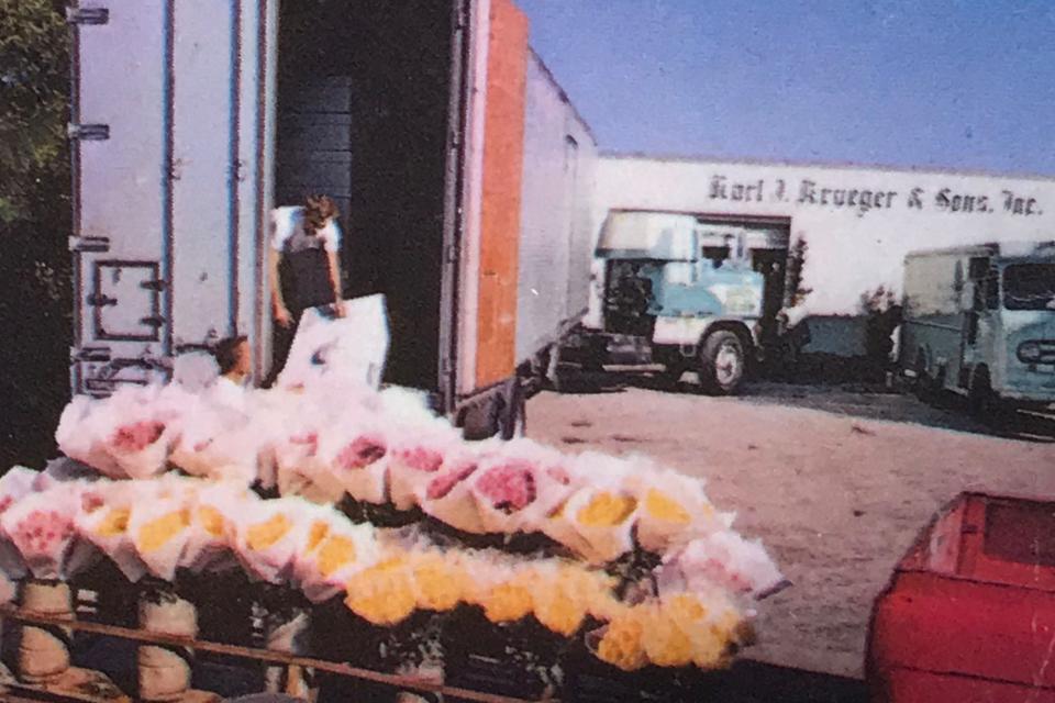 Karl John Jr and Edward Smith packing flowers for shipment up north, 1967.