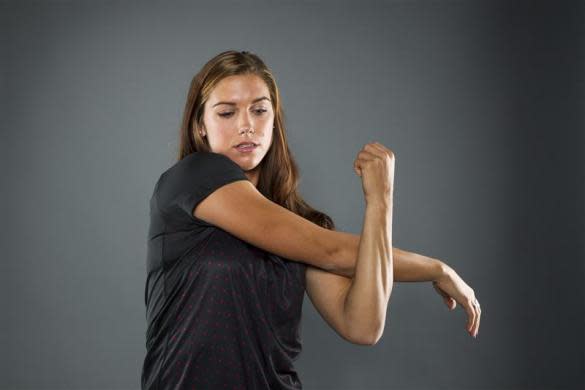 Soccer player Alex Morgan stretches while posing for a portrait during the 2012 U.S. Olympic Team Media Summit in Dallas, May 15, 2012.