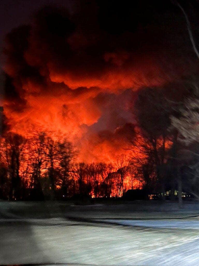 A fire from a train derailment lights the sky Friday night in this photo take by East Palestine, Ohio, resident Melissa Smith.