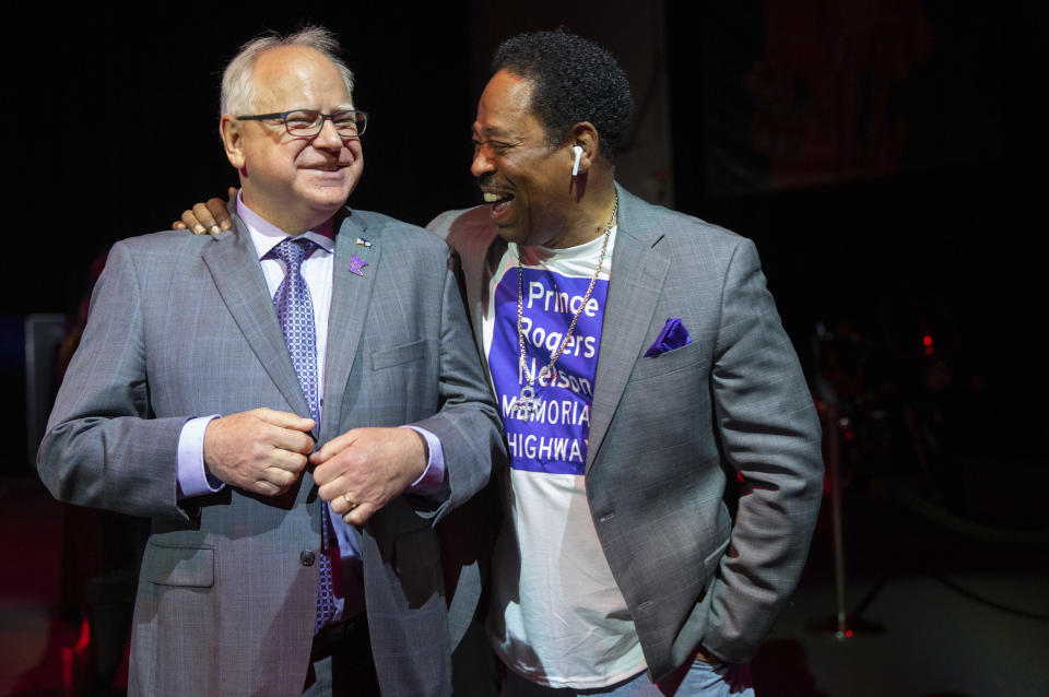 Minnesota Gov. Tim Walz and Mark Webster, a major advocate for the bill, share a laugh before the bill signing ceremony renaming a 7-mile stretch of Highway 5 as "Prince Rogers Nelson Memorial Highway", Tuesday, May 9, 2023, at Paisley Park in Chanhassen, Minn. (Alex Kormann/Star Tribune via AP)