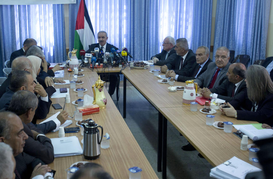 Palestinian Prime Minister Mohammed Shtayyeh, center, chairs a cabinet meeting in the Jordan Valley village of Fasayil, Monday, Sept. 16, 2019. Israeli Prime Minister Benjmin Netanyahu has vowed to annex "all the settlements" in the West Bank in a bid to whip up support as Israelis head to the polls Tuesday in the second election this year. To protest that announcement, the Palestinian Authority held a Cabinet meeting in the Jordan Valley on Monday, a day after Israel's Cabinet met elsewhere in the valley. (AP Photo/Majdi Mohammed)