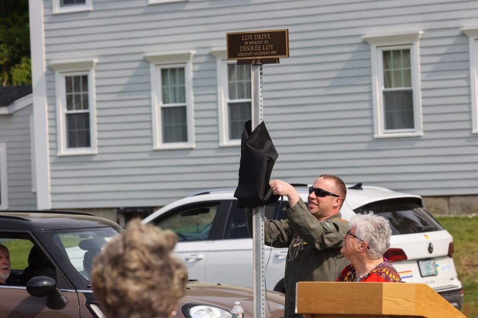 Keith Prochaska unveils a plaque in commemoration of NH Air National Guard Staff Sgt. Desiree Loy, who lost her life on Aug. 27, 1985, while on a training exercise at Beale Air Force Base in California.