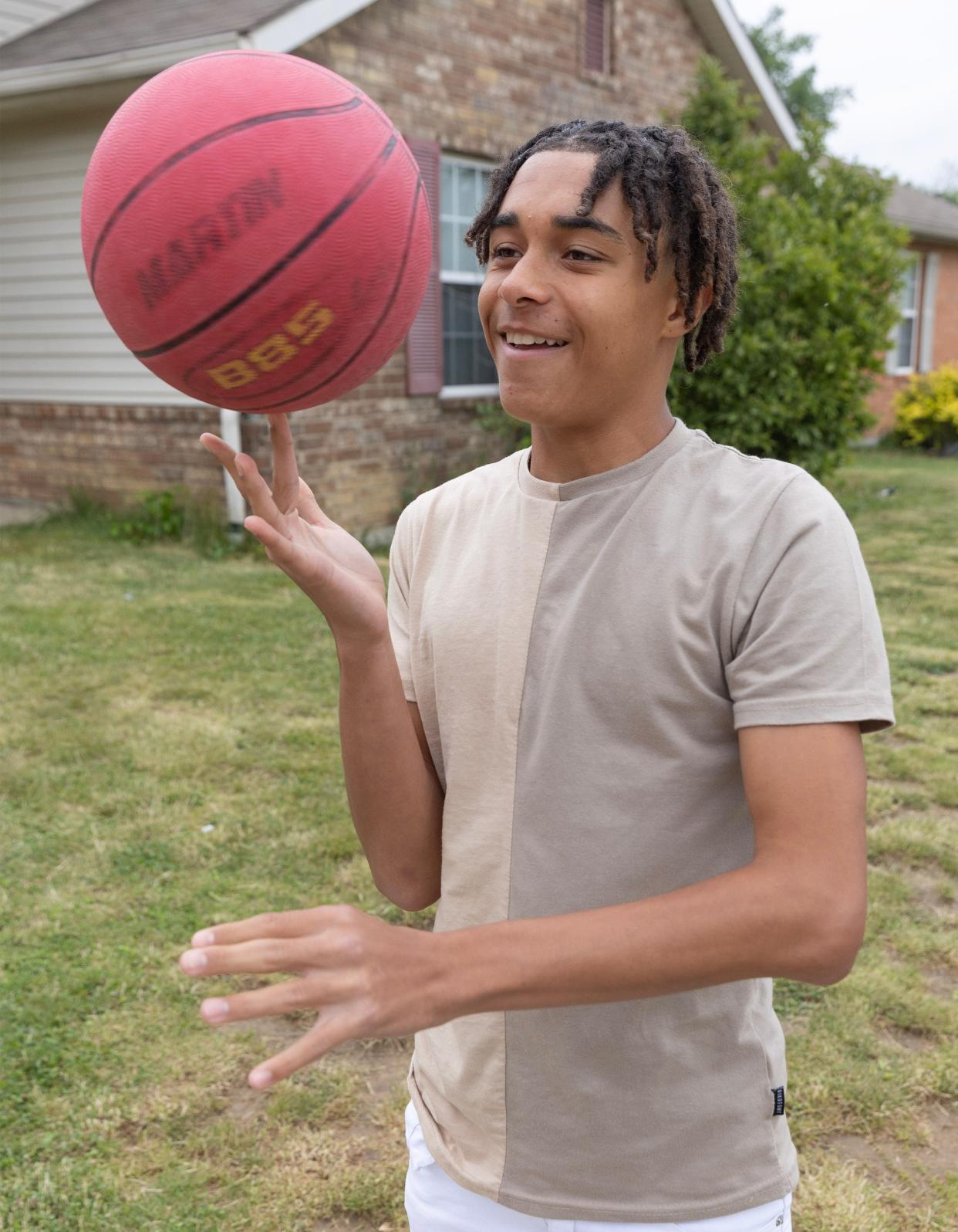 Armonnie Hawkins, 14, shows off some basketball skills at his Canton Township home. Armonnie was born with a heart murmur but has since been diagnosed with a heart disease he didn't know he had until he got a physical for sports.