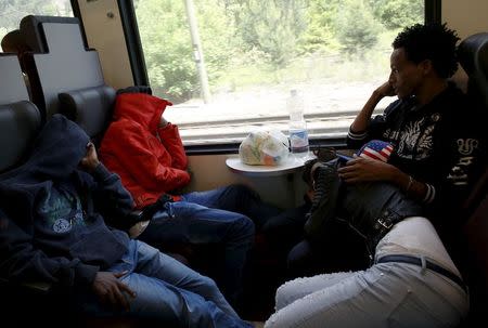 Dejen Asefaw (R), a 24-year-old Eritrean, travels by train with his girlfriend from Bolzano to Brenner, northern Italy, May 28, 2015. REUTERS/Stefano Rellandini