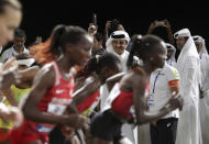 Emir of Qatar Sheikh Tamim bin Hamad Al Thani fires the starting pistol to get the women's marathon underway at the World Athletics Championships in Doha, Qatar, Saturday, Sept. 28, 2019. (AP Photo/Hassan Ammar)