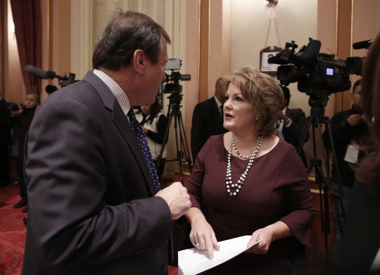 Freshman state Sen. Shannon Grove, R-Bakersfield, right, talks with Sen. Scott Wilk, R-Santa Clarita, during the state Senate session, Monday, Dec. 3, 2018, in Sacramento, Calif. Grove, who was elected in November to fill the seat vacated by Jean Fuller, who was termed out, and the rest of the members of the Senate took their oath of office to kick-off the new two-year legislative session. (AP Photo/Rich Pedroncelli)