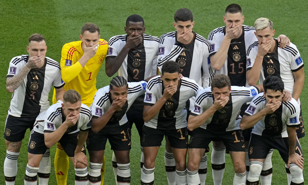 Germany's soccer team players cover their mouths as they pose for a group photo before the World Cup group E soccer match between Germany and Japan, at the Khalifa International Stadium in Doha, Qatar, Wednesday, Nov. 23, 2022. (AP Photo/Ricardo Mazalan)
