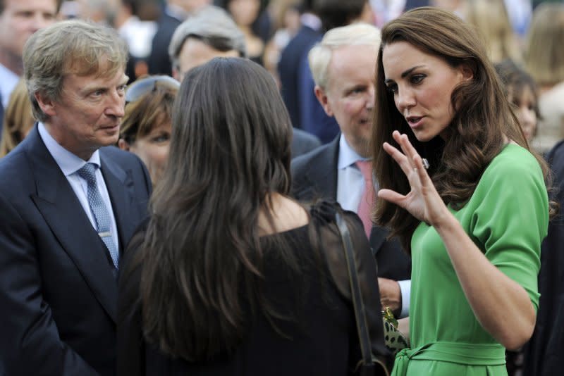 Kate, the Duchess of Cambridge, mingles with guests including television producer Nigel Lythgoe, far left, during a private reception at the British Consul-General's residence in Los Angeles in 2011. File Photo by Chris Pizzello/pool