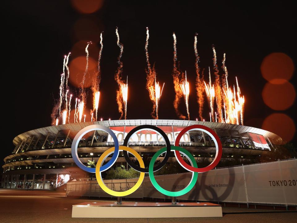 Olympic rings and fireworks outside of Tokyo Stadium.