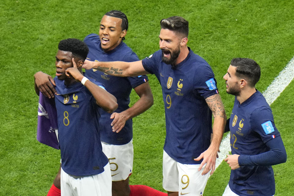 France's Aurelien Tchouameni, left, celebrates after scoring his side's opening goal during the World Cup quarterfinal soccer match between England and France, at the Al Bayt Stadium in Al Khor, Qatar, Saturday, Dec. 10, 2022. (AP Photo/Hassan Ammar)