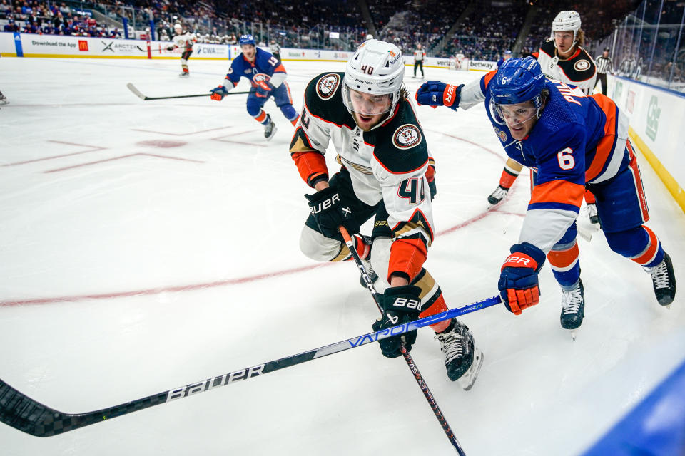 Anaheim Ducks left wing Pavol Regenda (40) and New York Islanders defenseman Ryan Pulock (6) fight for the puck during the first period of an NHL hockey game, Saturday, Oct. 15, 2022, in Elmont, N.Y. (AP Photo/Julia Nikhinson)