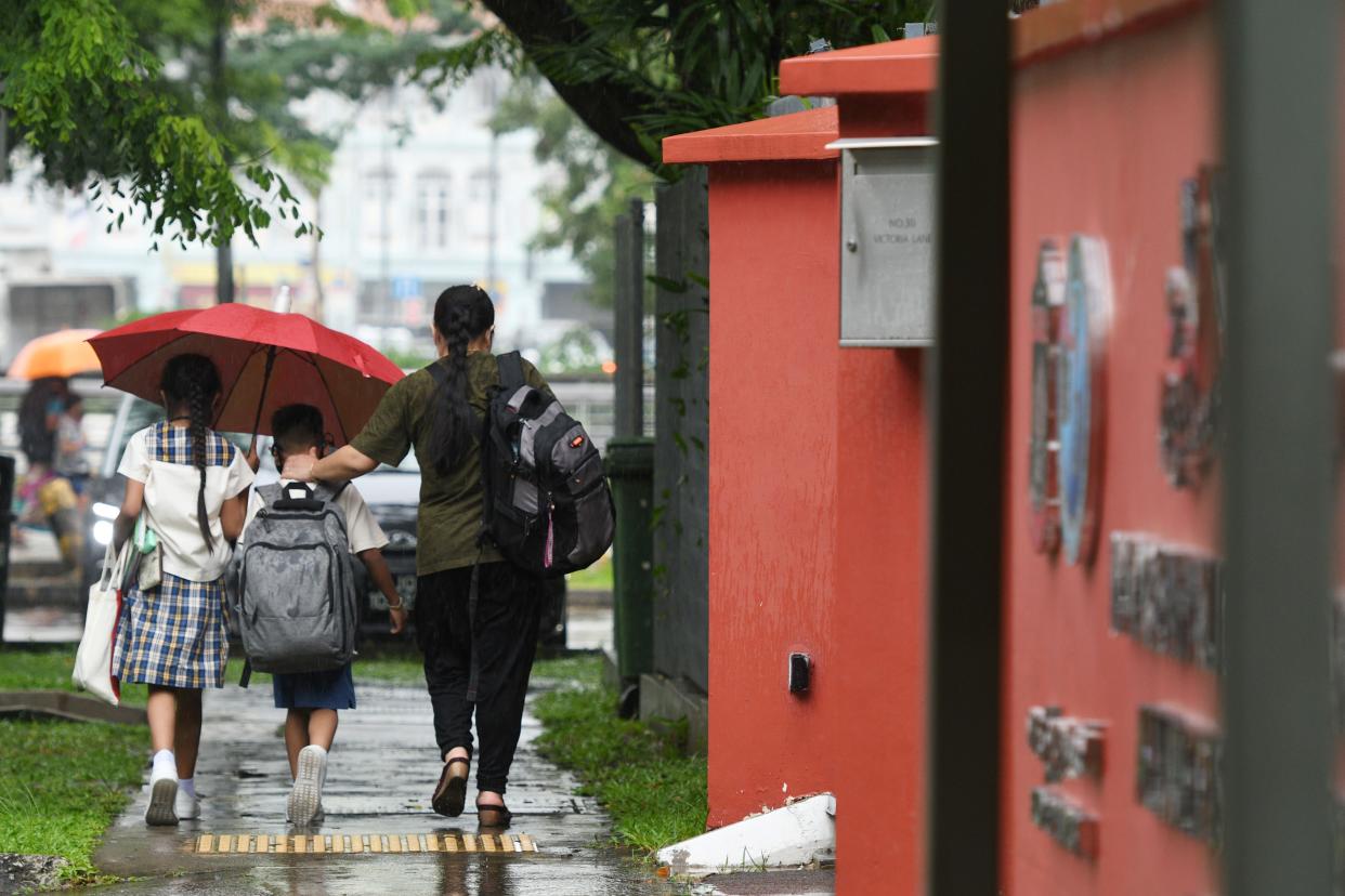 Pupils leave their school after class in Singapore.