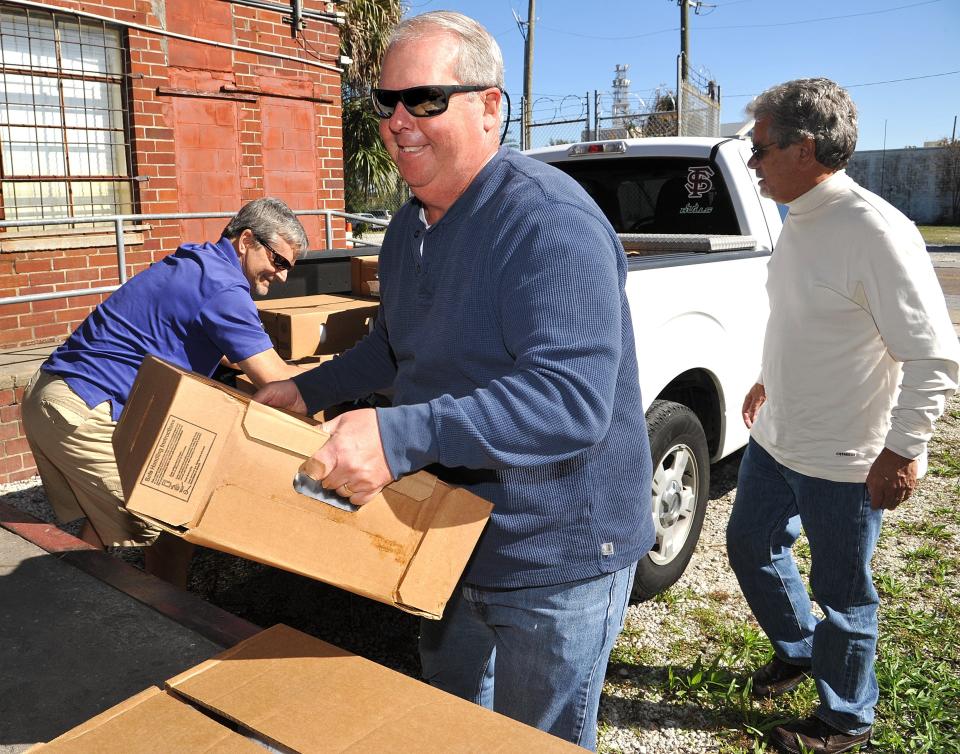 Casey Jones, center, one of the survivors of the "Miracle on the Hudson" plane crash, and his volunteers deliver 315 frozen turkeys to The Salvation Army on Nov. 23, 2015.