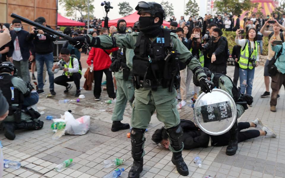 Police arresting protesters at a rally in support of Uighurs' human rights in Hong Kong - LUCY NICHOLSON /REUTERS