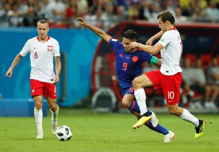 Soccer Football - World Cup - Group H - Poland vs Colombia - Kazan Arena, Kazan, Russia - June 24, 2018 Colombia's Radamel Falcao in action with Poland's Grzegorz Krychowiak REUTERS/John Sibley