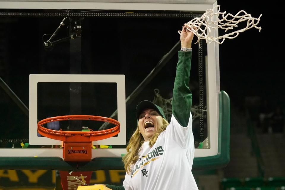 Celebrating the Big 12 regular season champion title, Baylor head coach Nicki Collen waves the cut net after an NCAA college basketball game against Texas Tech in Waco, Texas, Sunday, March 6, 2022. (AP Photo/LM Otero)