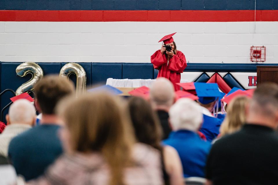 Natalie Holbrook, class president at Indian Valley High School, takes a picture shortly before delivering her speech during the 35th commencement ceremony, Sunday, May 19 in Gnadenhutten.