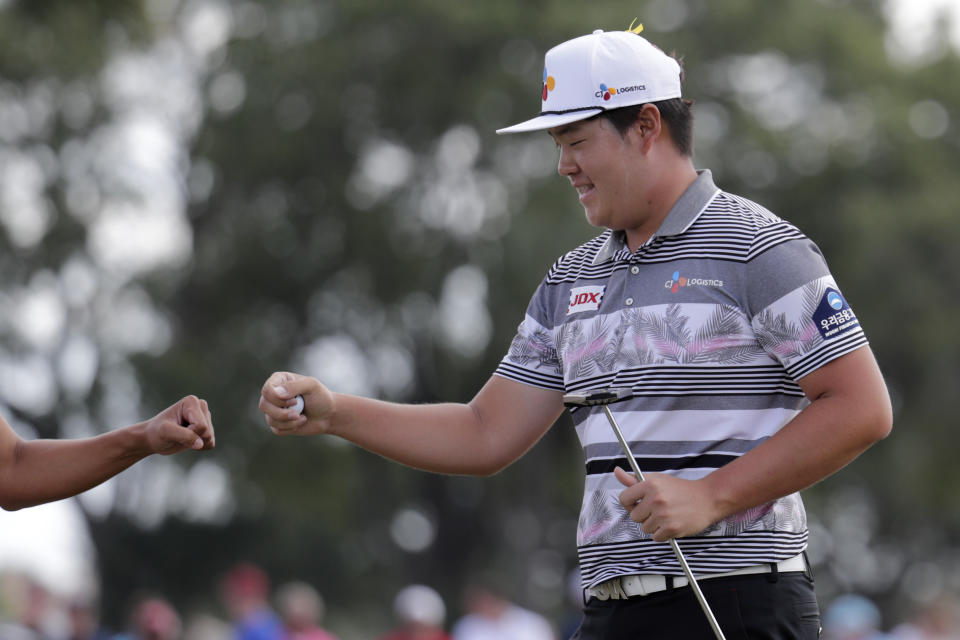 Sungjae Im of South Korea bumps fists with his caddie after saving par on the sixth hole during the fourth round of the Honda Classic golf tournament, Sunday, March 1, 2020, in Palm Beach Gardens, Fla. (AP Photo/Lynne Sladky)