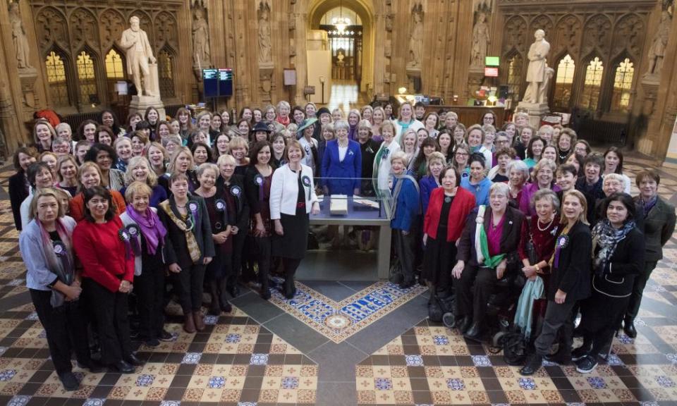 Theresa May, centre, and female parliamentarians gather in the central lobby to celebrate the centenary of the Representation of the People Act, 6 February 2018