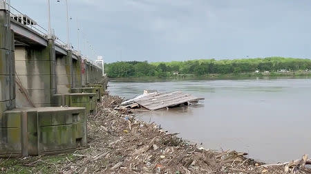 A house on the Arkansas River, that floated away, hits the Ozark-Jeta Taylor Lock & Dam in Ozark, Arkansas, U.S., May 23, 2019 in this still image obtained from a social media video on May 23, 2019. STEVEN WRIGHT/via REUTERS