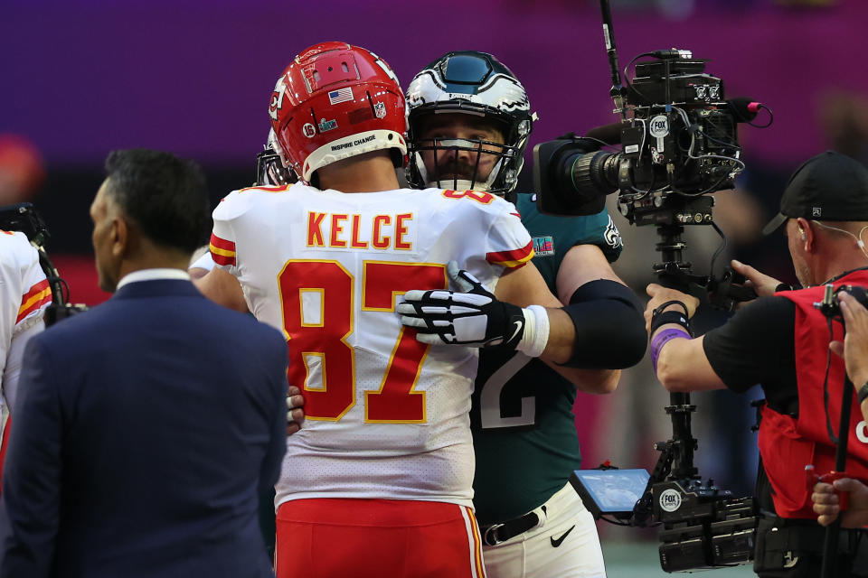 GLENDALE, ARIZONA - FEBRUARY 12: Travis Kelce #87 of the Kansas City Chiefs hugs Jason Kelce #62 of the Philadelphia Eagles before Super Bowl LVII at State Farm Stadium on February 12, 2023 in Glendale, Arizona. (Photo by Ezra Shaw/Getty Images)