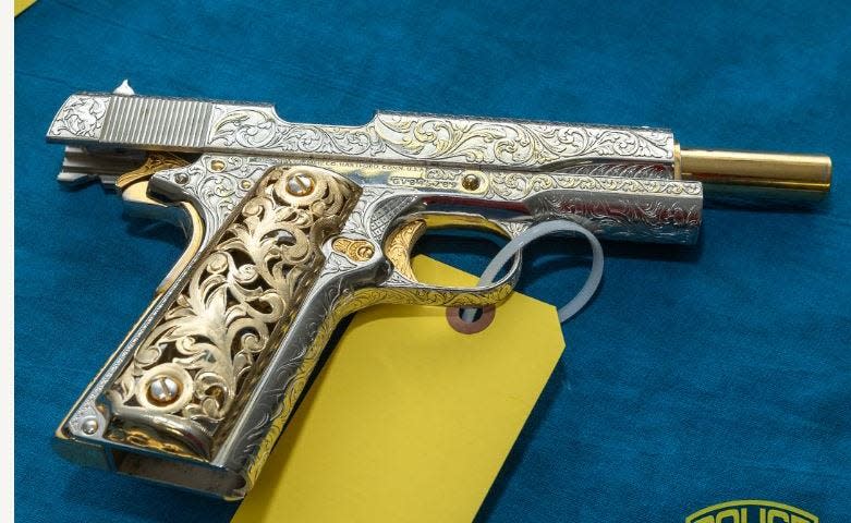 Among the guns seized was this 1911 Colt with fancy engravements.