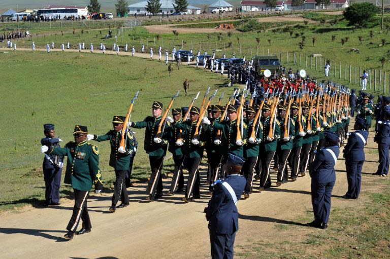 The coffin of South African former president Nelson Mandela is escorted to the compound for his funeral ceremony in Qunu on December 15, 2013