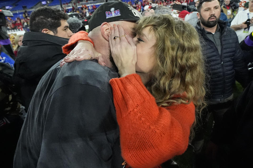 Taylor Swift speaks with Kansas City Chiefs tight end Travis Kelce after an AFC Championship NFL football game against the Baltimore Ravens, Sunday, Jan. 28, 2024, in Baltimore. The Kansas City Chiefs won 17-10. (AP Photo/Julio Cortez)