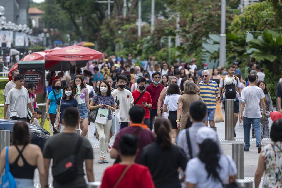 Pedestrians at Orchard Road in Singapore, on Saturday, Feb. 11, 2023. 