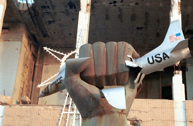 A Libyan hand holds a crushed US fighter jet in this sculpture located on the grounds of Libyan leader Muammar Al Qadhafi’s compound February 1, 2001 in Tripoli