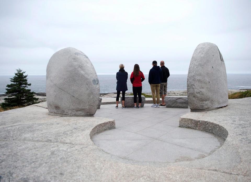 Visitors look out on the waters as they visit the Swissair memorial at Whalesback near Peggys Cove, N.S. on Thursday, Sept. 1, 2016. On Sept. 2, 1998, Swissair Flight 111, flying from New York to Zurich, crashed into the Atlantic Ocean near the community. All 229 people on board perished. 