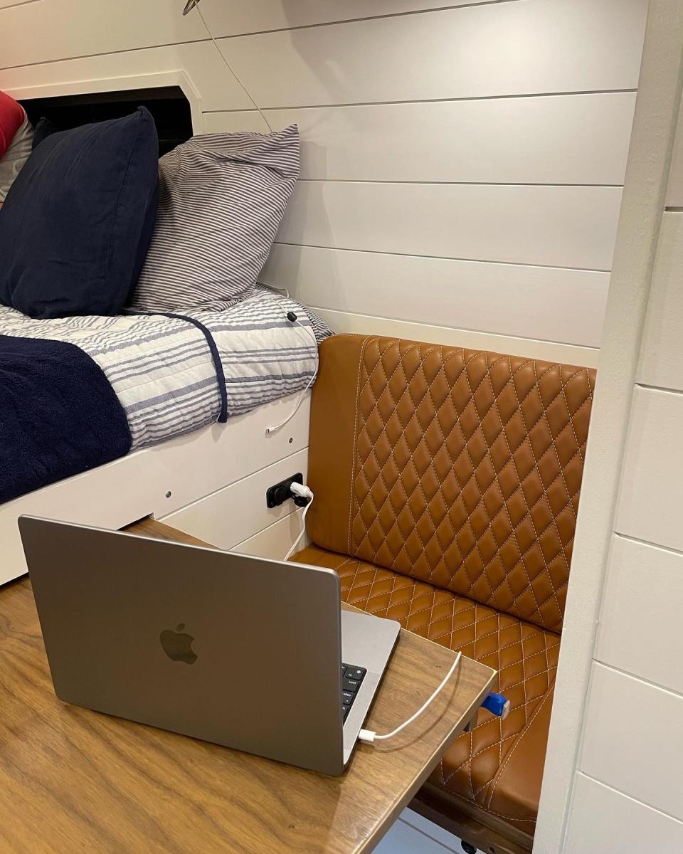 The work area in the van with a laptop on a desk